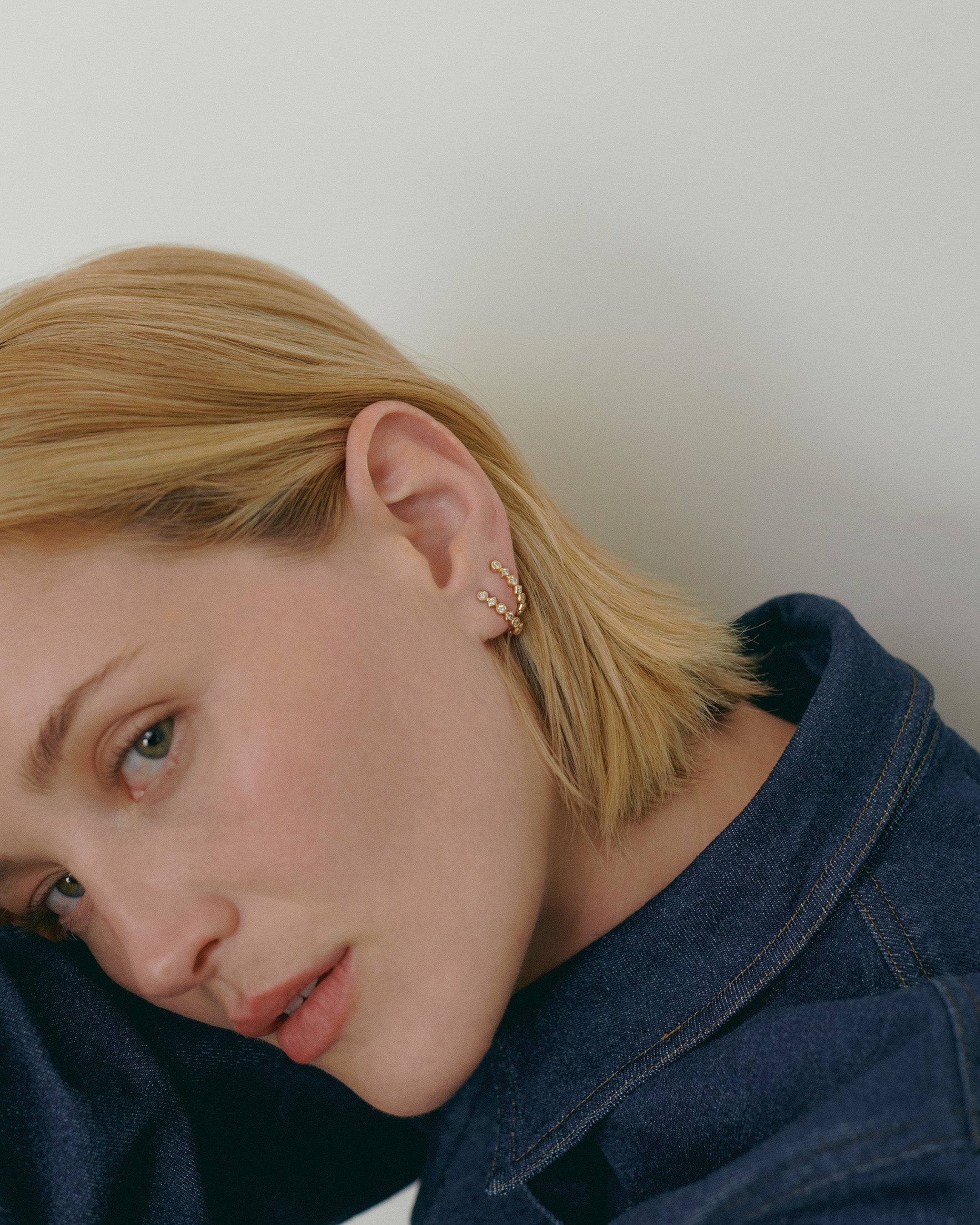 Close-up of a person wearing a felico earing