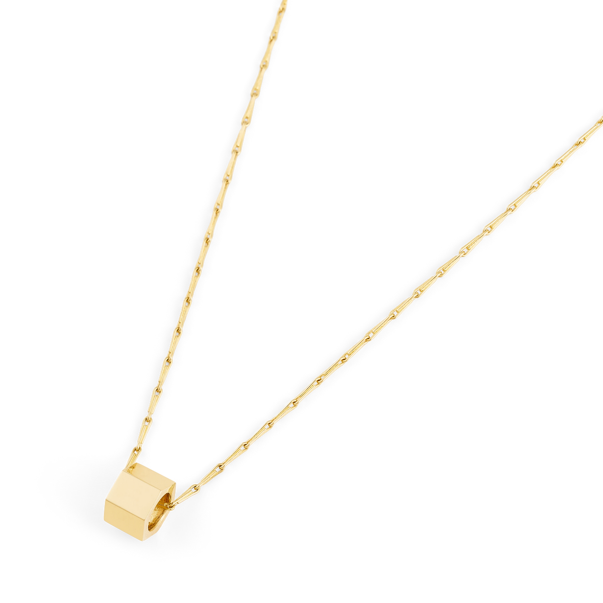 Close-up of the Bolto octagon bolt pendant in yellow gold on a Spiko chain - Daure collection