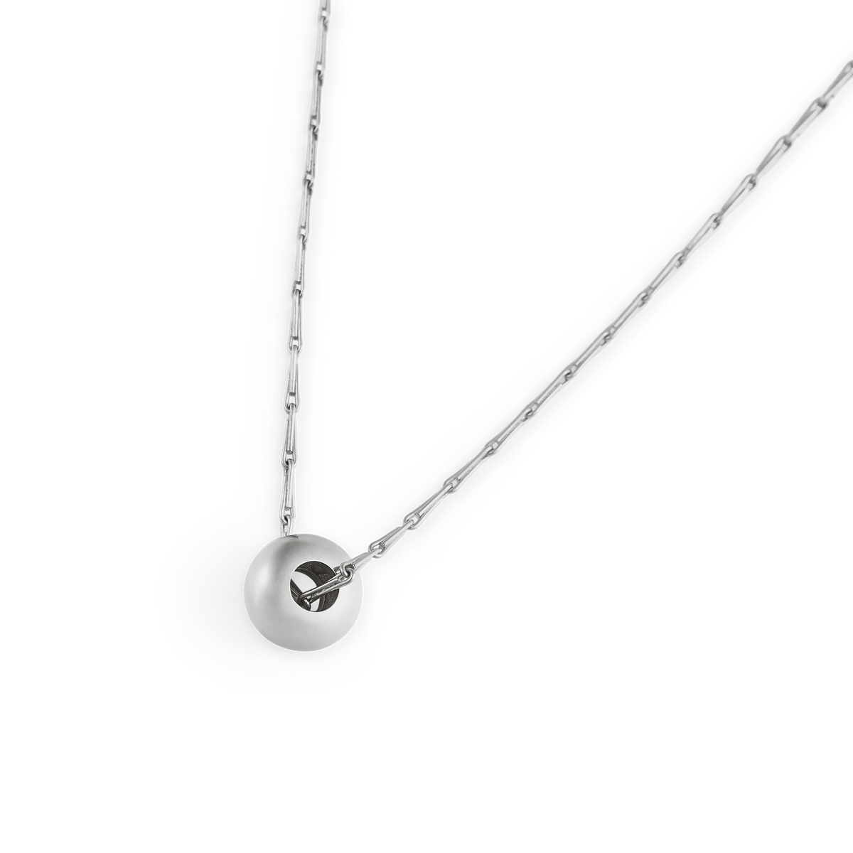 Close-up of the Pilko satin-finish sterling silver ball pendant on a Spiko chain - Daure collection