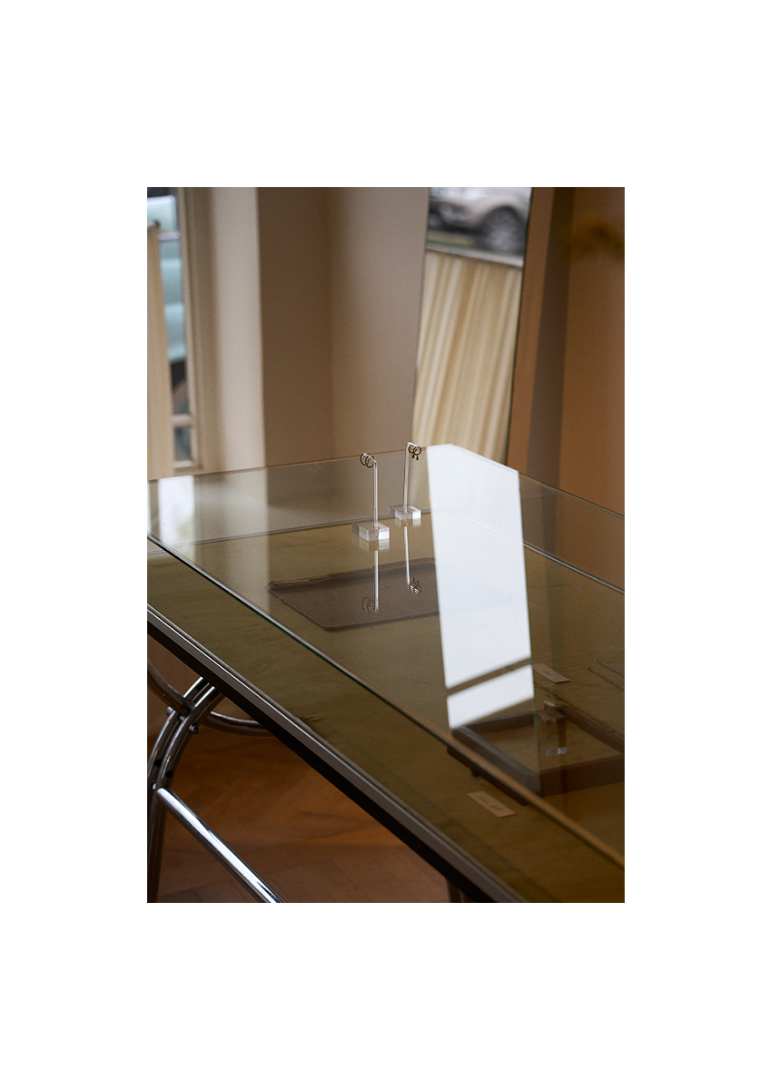 Modern glass desk with metal legs in a minimalistic office setting