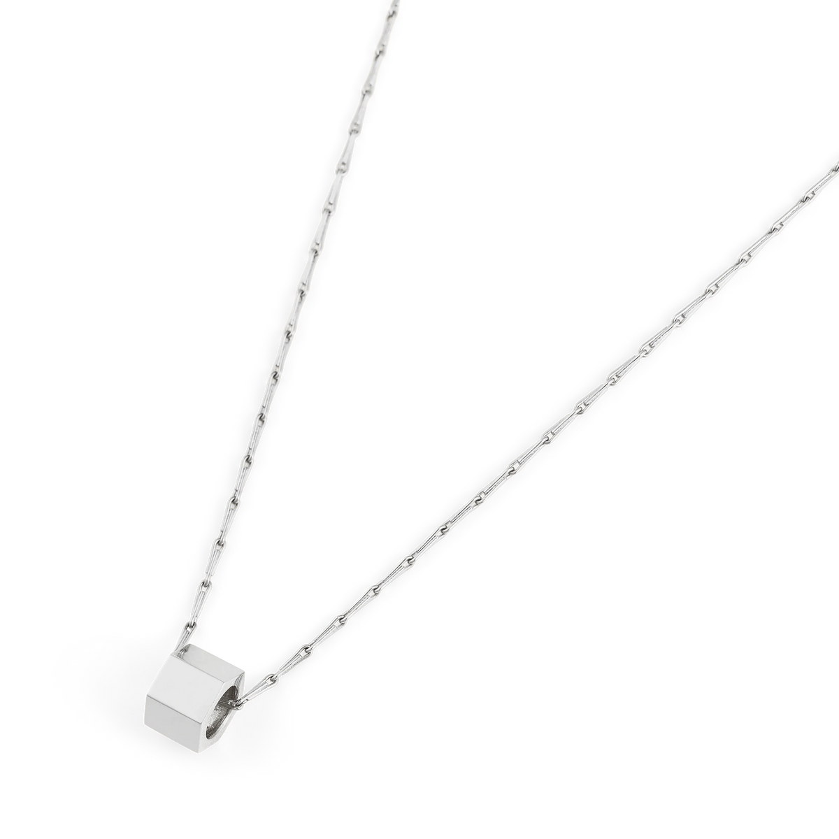 Close-up of the Bolto octagon bolt pendant in polished sterling silver on a Spiko chain - Daure collection